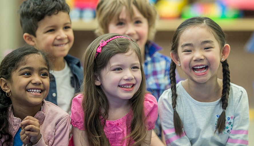 A group of kindergarten children--3 girls and 2 boys-- happy and smiling