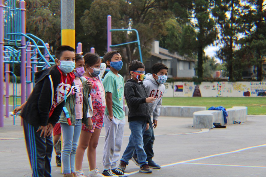 boys and girls line up on the school playground
