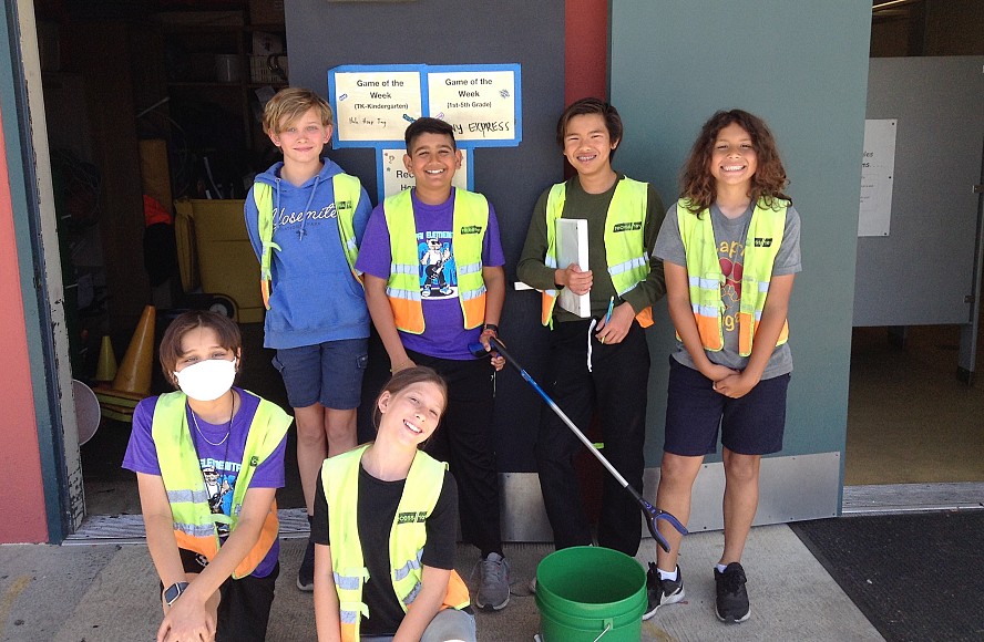 six elementary students in yellow vests smiling
