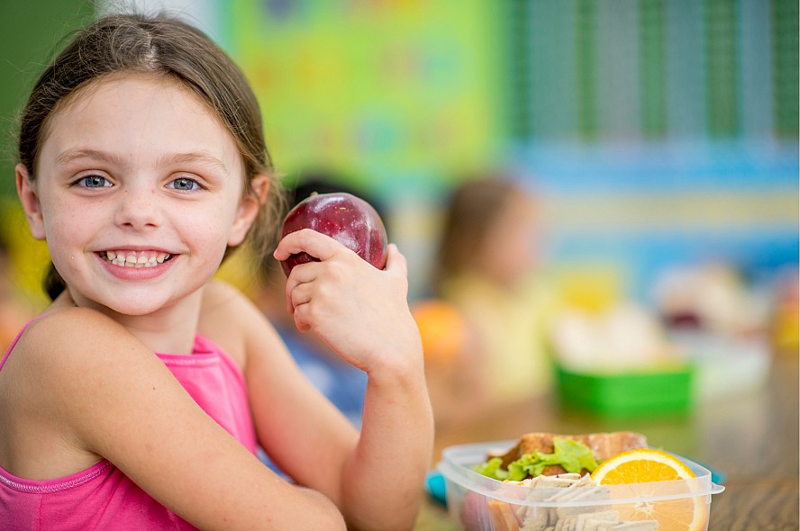 smiling child with an apple