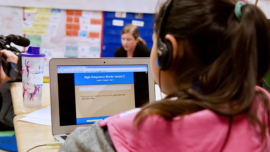 child working on computer in classroom