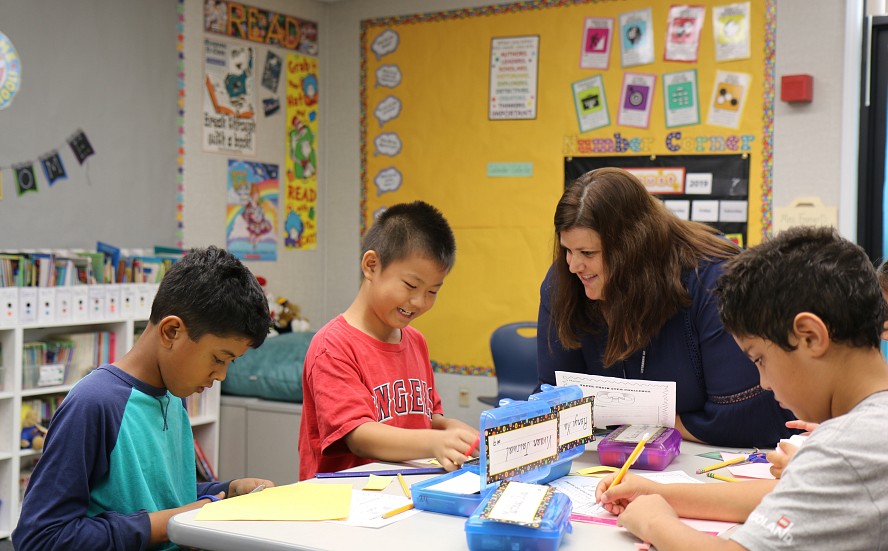teacher working with students