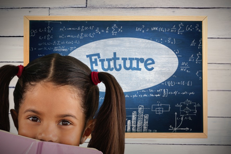 young, dark haired girl with pig tails is peeking over the top of her open book. behind her is a blackboard with the word 