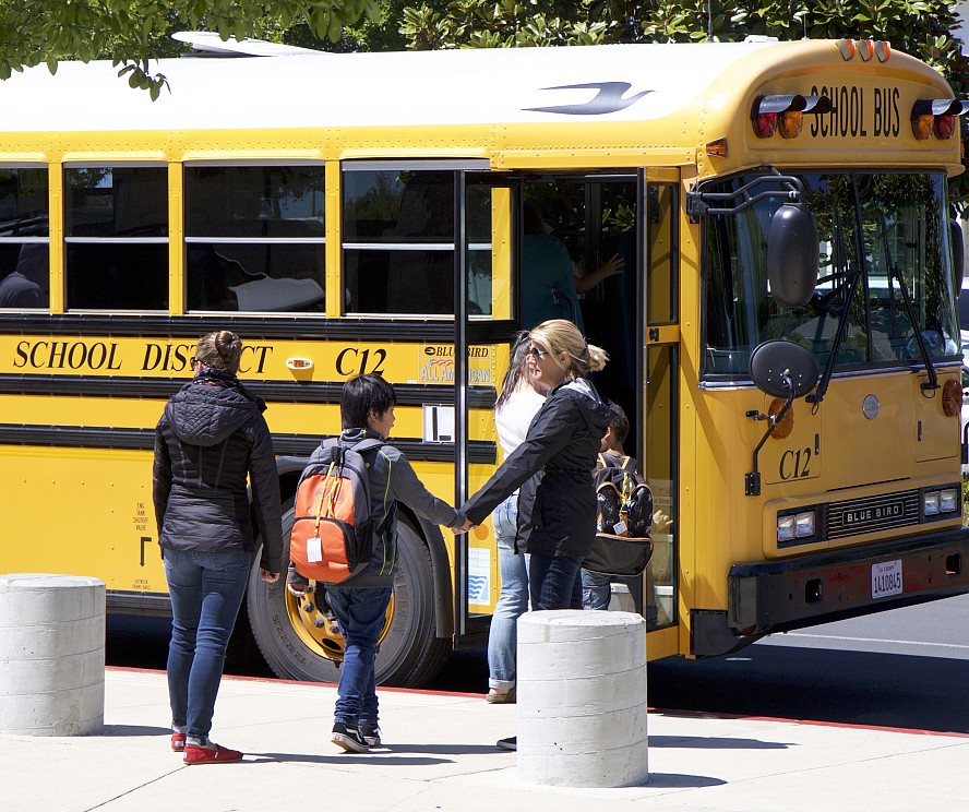 children boarding school bus