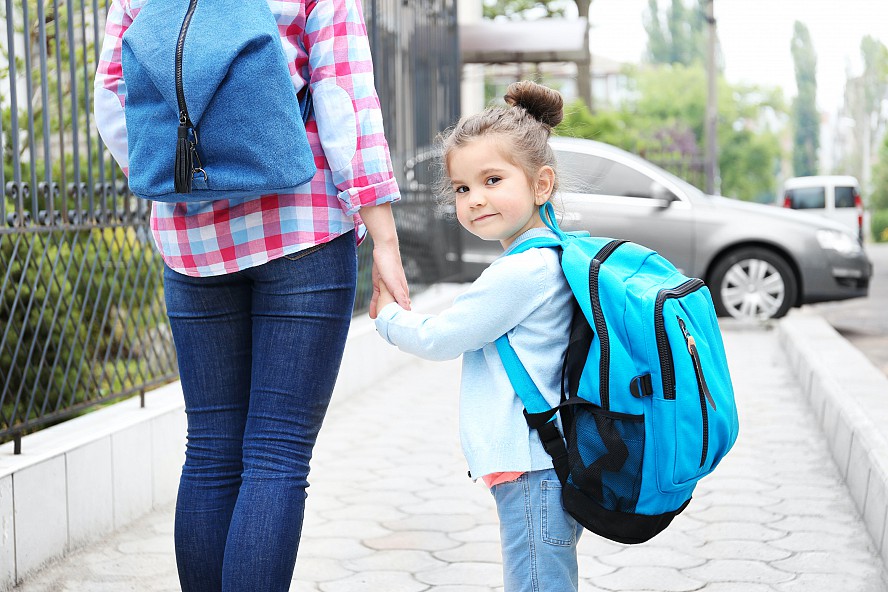 parent and child walk to school