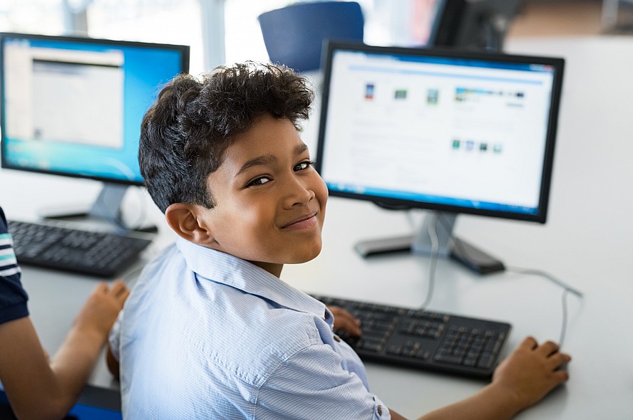 boy smiling at computer