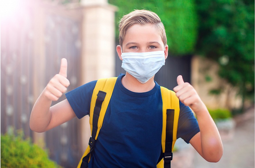 boy wearing mask with thumbs up