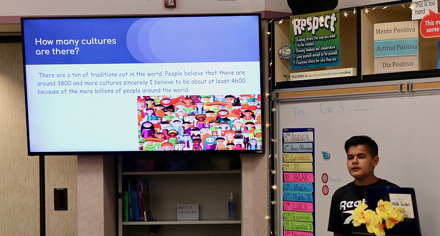 boy standing near large screen 