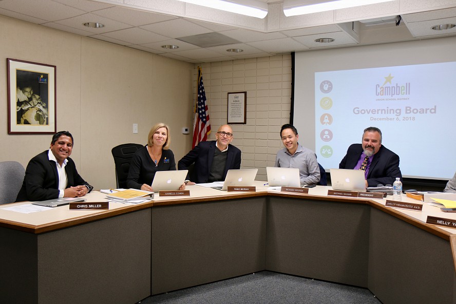 5 governing board members at dais