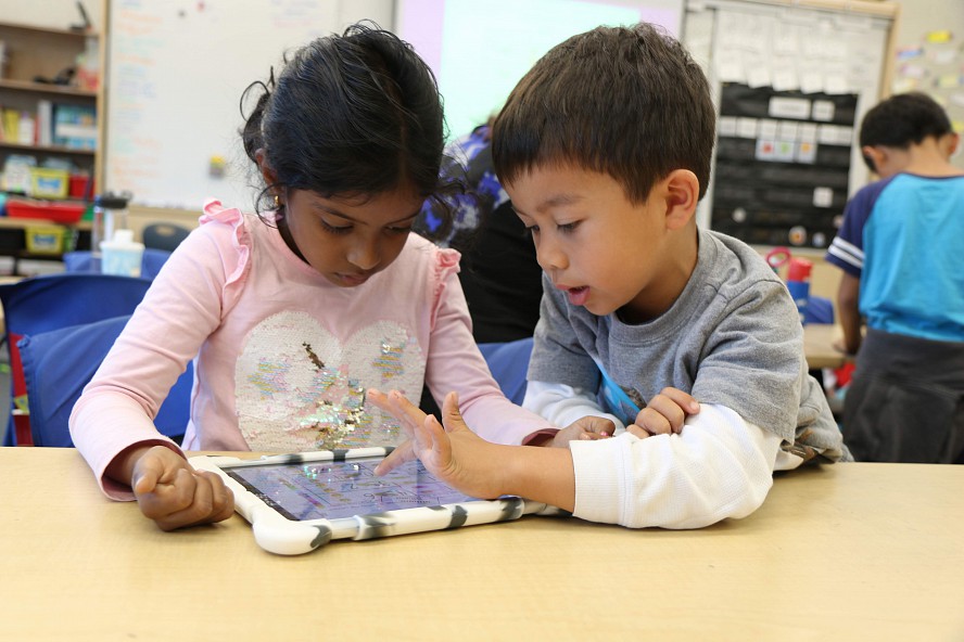 two young students with laptop