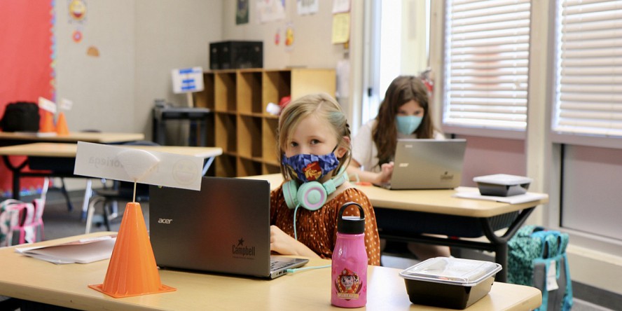 students wearing masks working at desks
