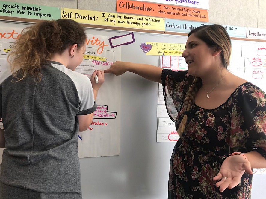 teacher jennifer bell talks to student