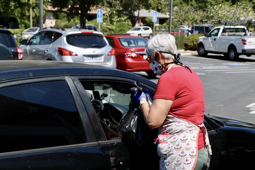 meals being handed to person in car