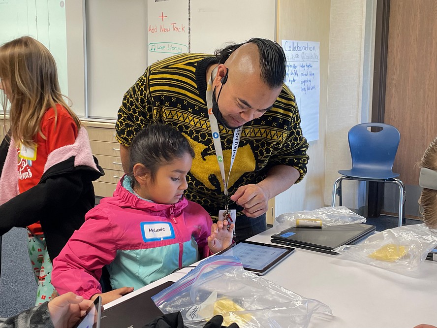 teacher works one-on-one with student