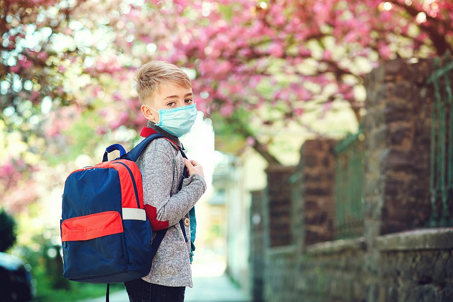 boy with backpack and mask