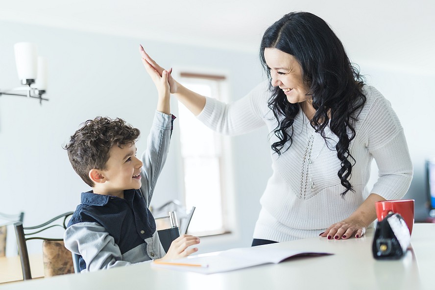 child and parent high fiving