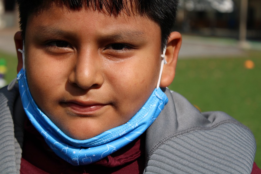 boy with mask on chin