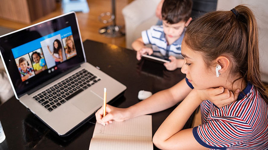 girl does school work at home