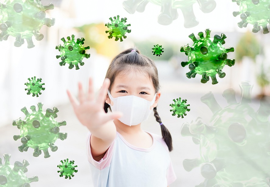 young girl wearing mask. hand pushes away germs