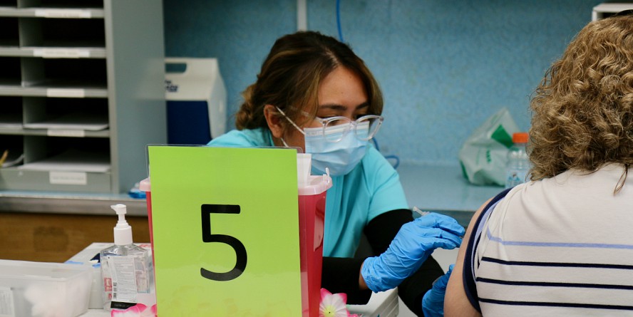 woman gives injection to another