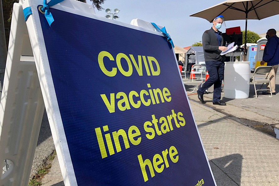sign showing COVID19 vaccine line
