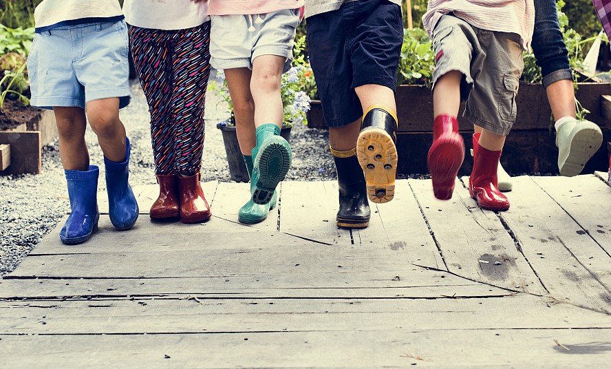 children's feet in boots taking a step forward