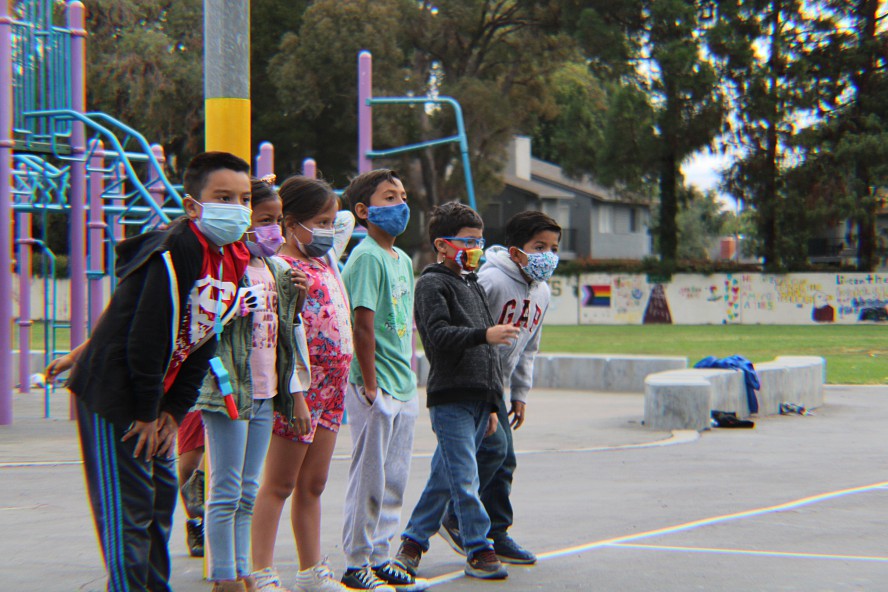 boys and girls line up on the school playground