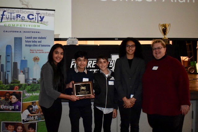 students and teacher smiling at awards presentation