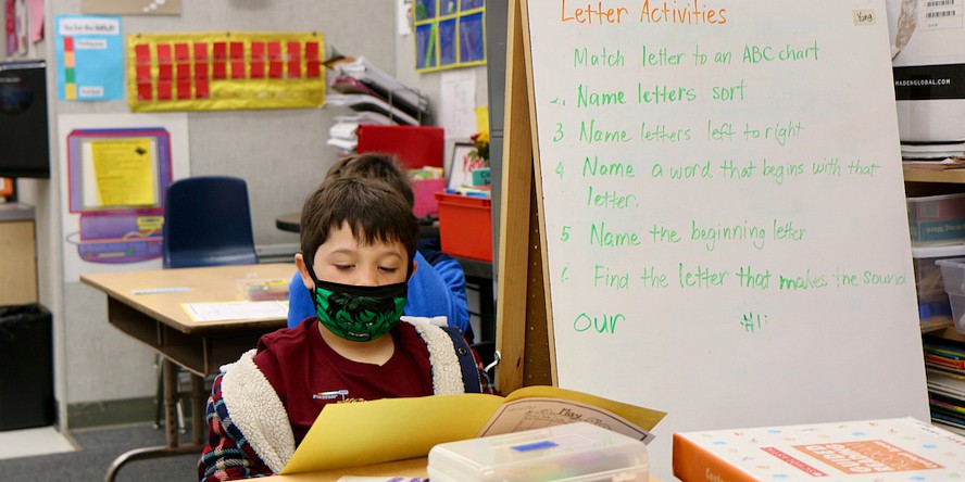 student reading wearing mask