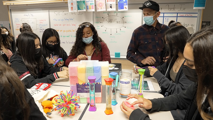 students at table working on crafts