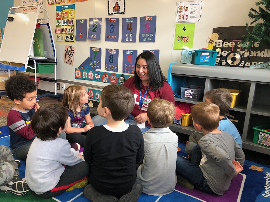 woman showing preschoolers the letter Y