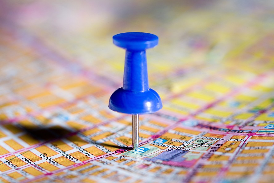 blue pushpin on a map