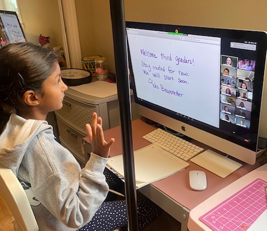 girl sitting at computer and learning at home 