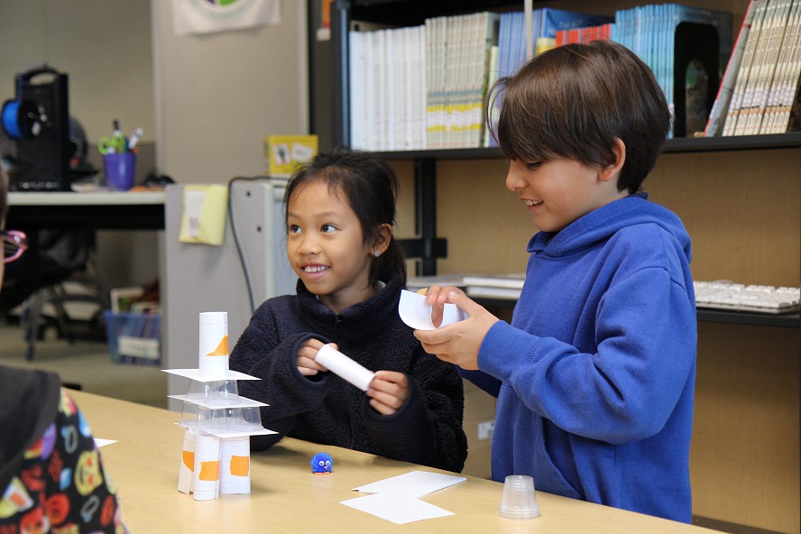 students build a tower from paper and tape