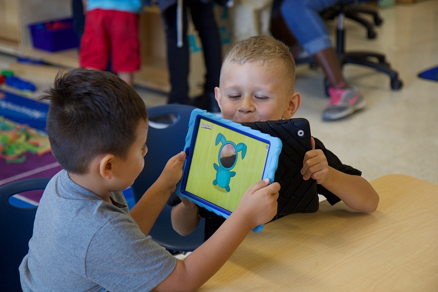 young students learning with technology