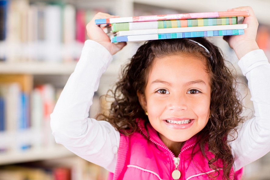 girl smiling holding books