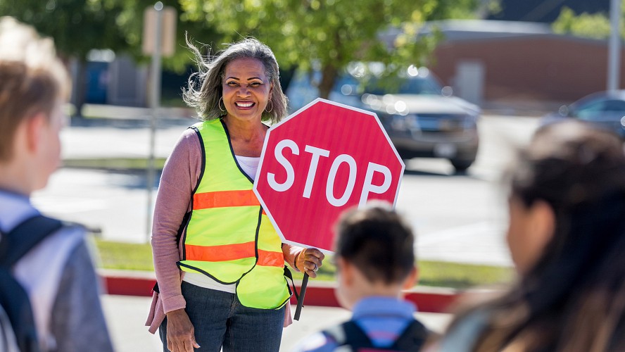 smiling woman crossing guard