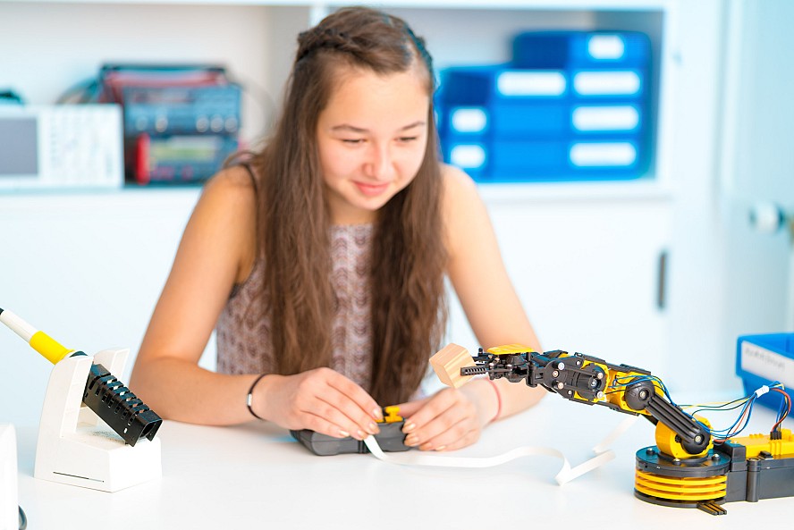 girl works on robotics project