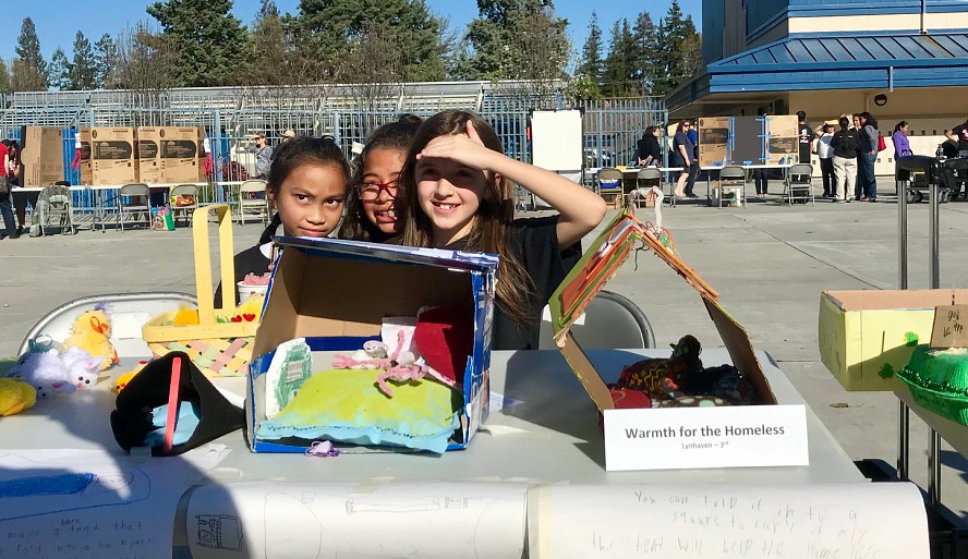 students with display at STEAM showcase