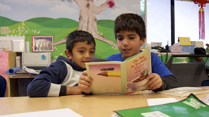 two boys reading together