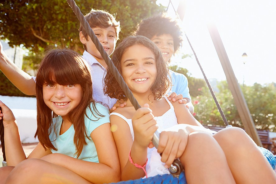 group of smiling kids at playground