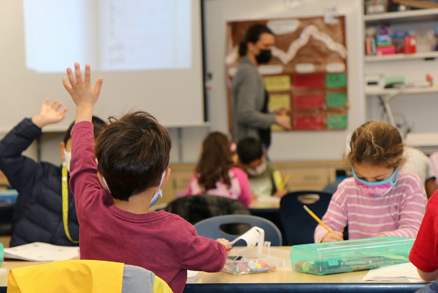 student raising hand in class