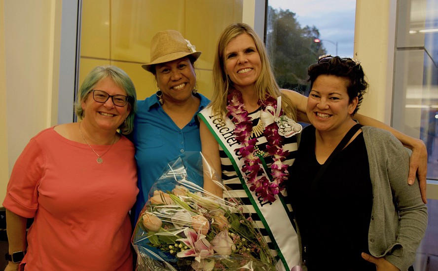 four women smiling--one is teacher of the year
