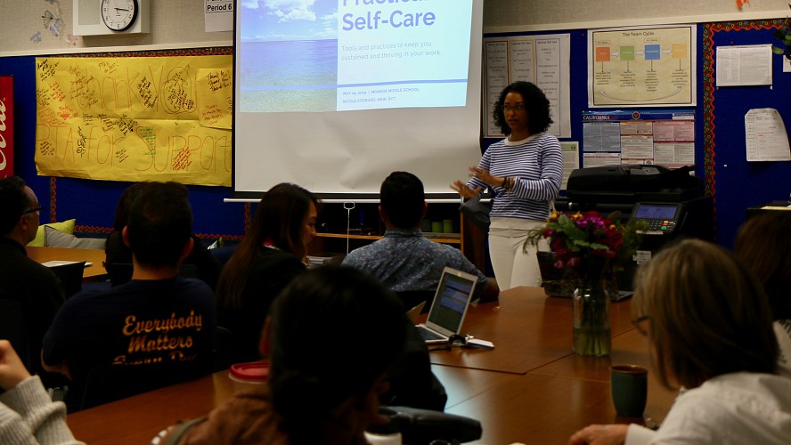 staff listens to self-care presentation