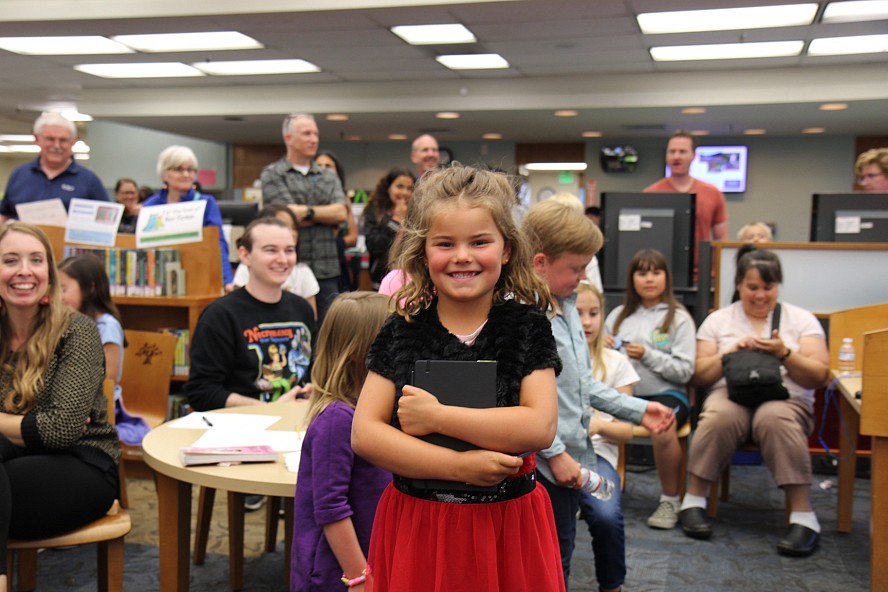 young girl happy holding a book