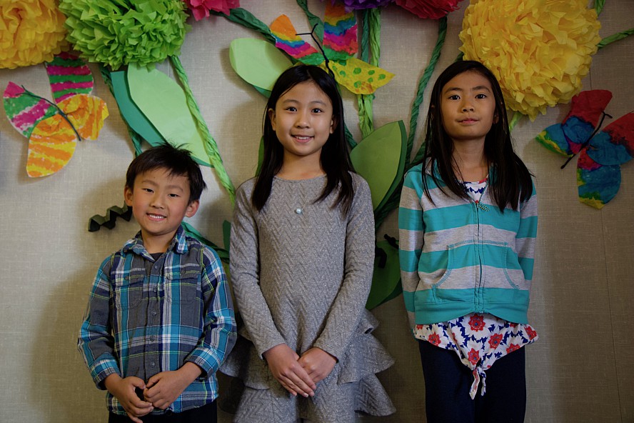 three students smiling