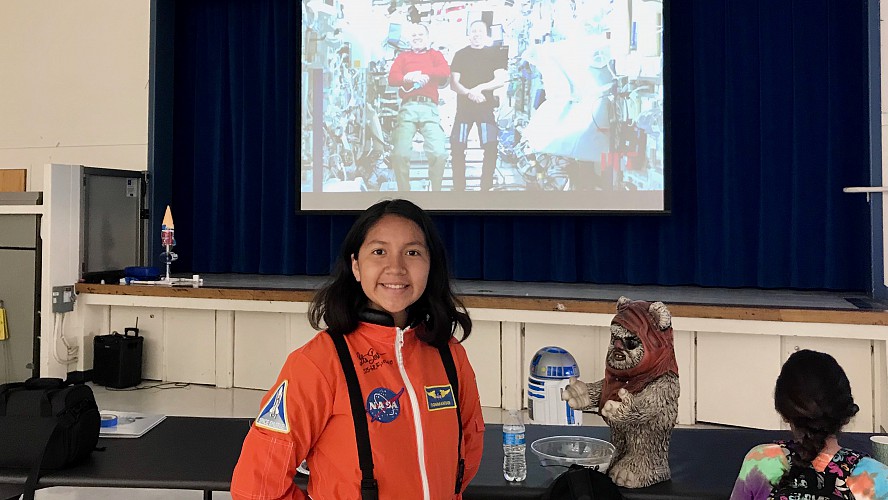 student wearing orange astronaut jumpsuit