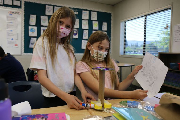 two young girls show their prototype