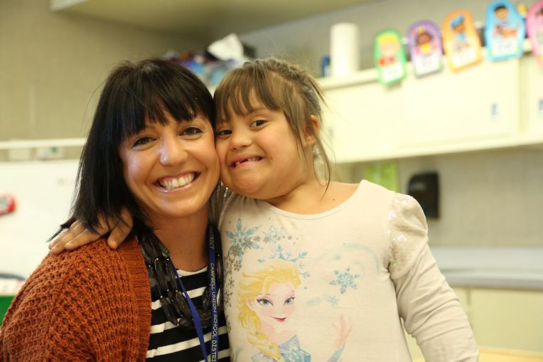 teacher and student smiling