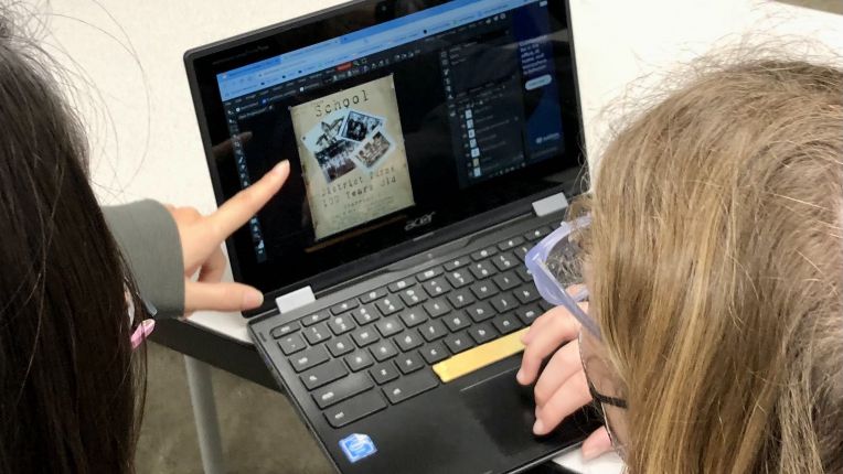 student with laptop showing magazine art